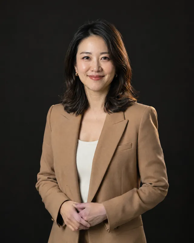 Founder of a growing clinic group in a camel blazer
